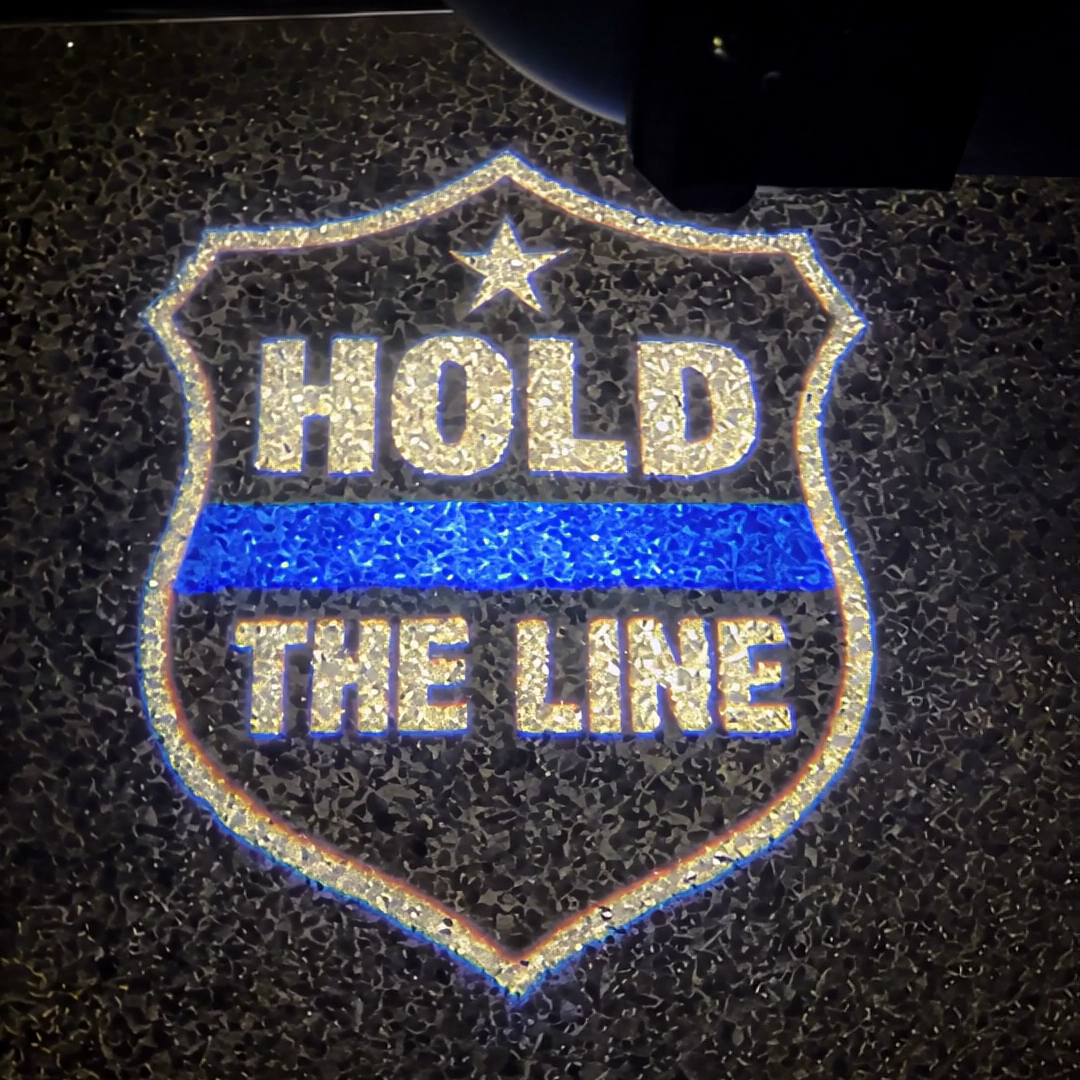 The Hold The Line shield projected on the pavement
