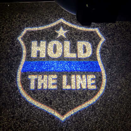 The Hold The Line shield projected on the pavement