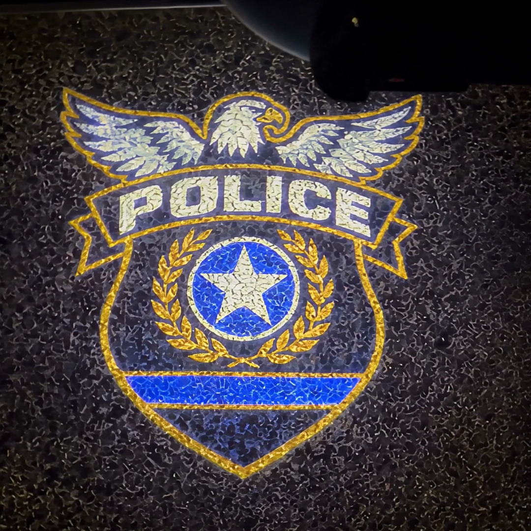 The police badge projected on the pavement
